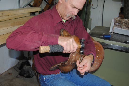 2015 Sept 8 1 Rod pounding seams on a saddle tree.jpg